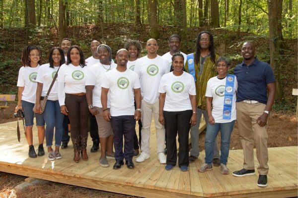 Community group wearing logo shirts in woods