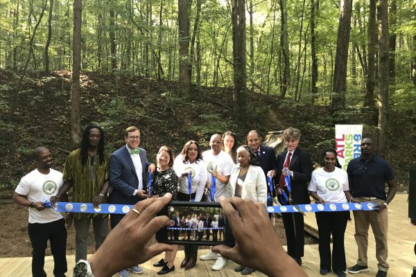A group of people standing around a forest.