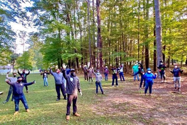 Masked group socially distanced in wooded park