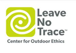 A green and white logo for the leave no trace center.