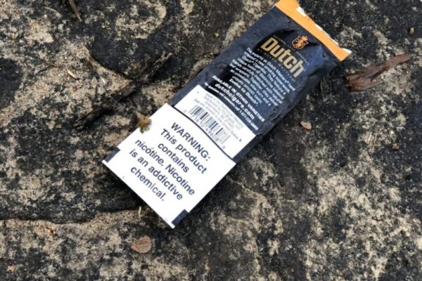 A cigarette pack laying on the ground.