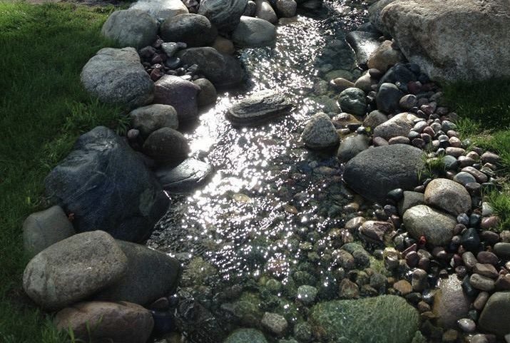 A stream of water flowing over rocks.