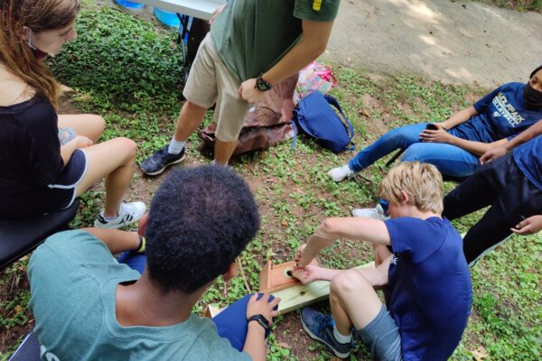 A group of people sitting on the ground