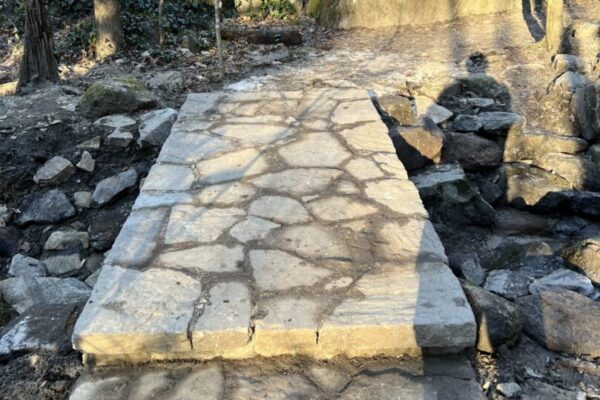 A stone path with steps leading to the top of it.