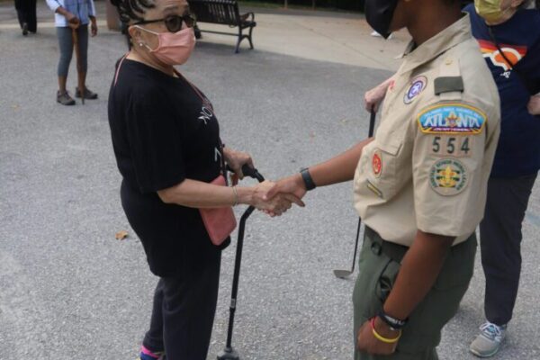 A girl shaking hands with an official.