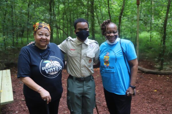 A group of people standing in the woods.