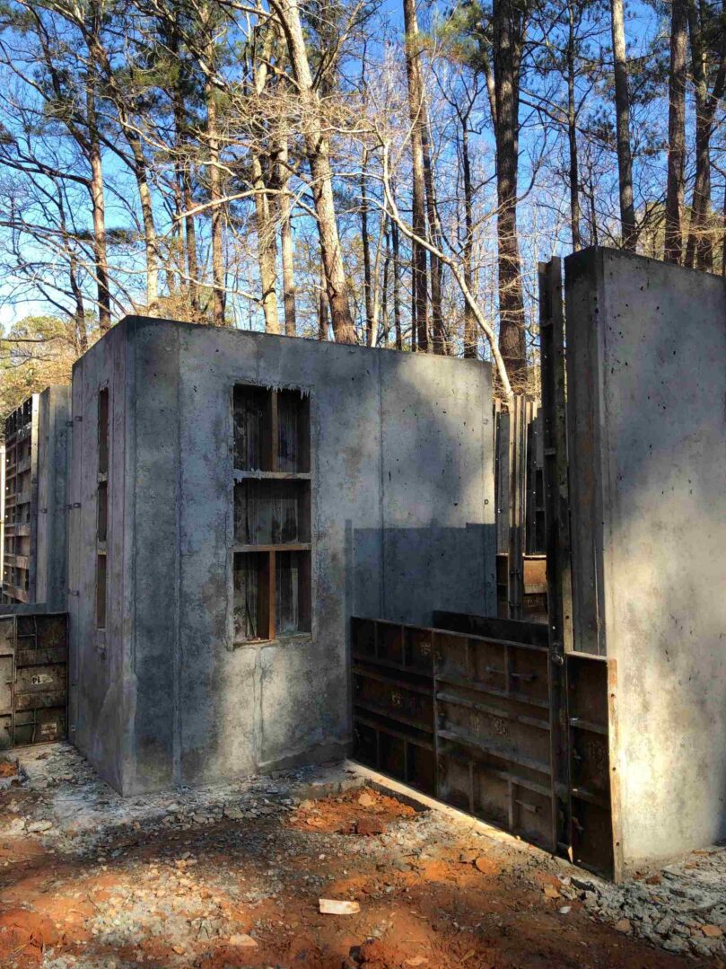 A concrete structure in the middle of a forest.