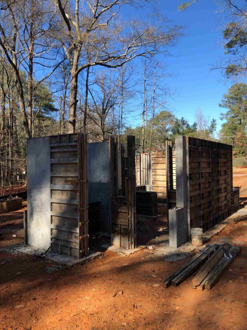 A building that is being built in the dirt.