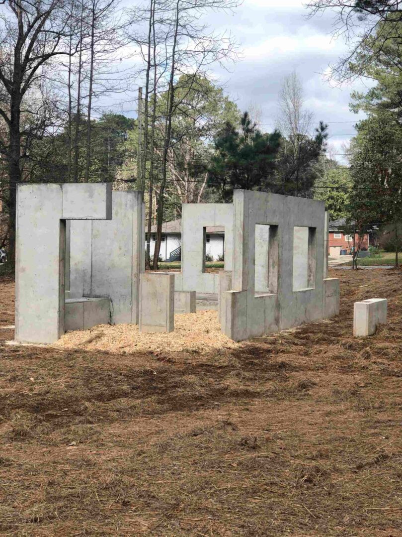 A concrete structure that is being built in the dirt.