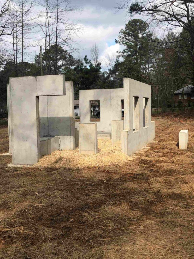 A concrete structure in the middle of a field.