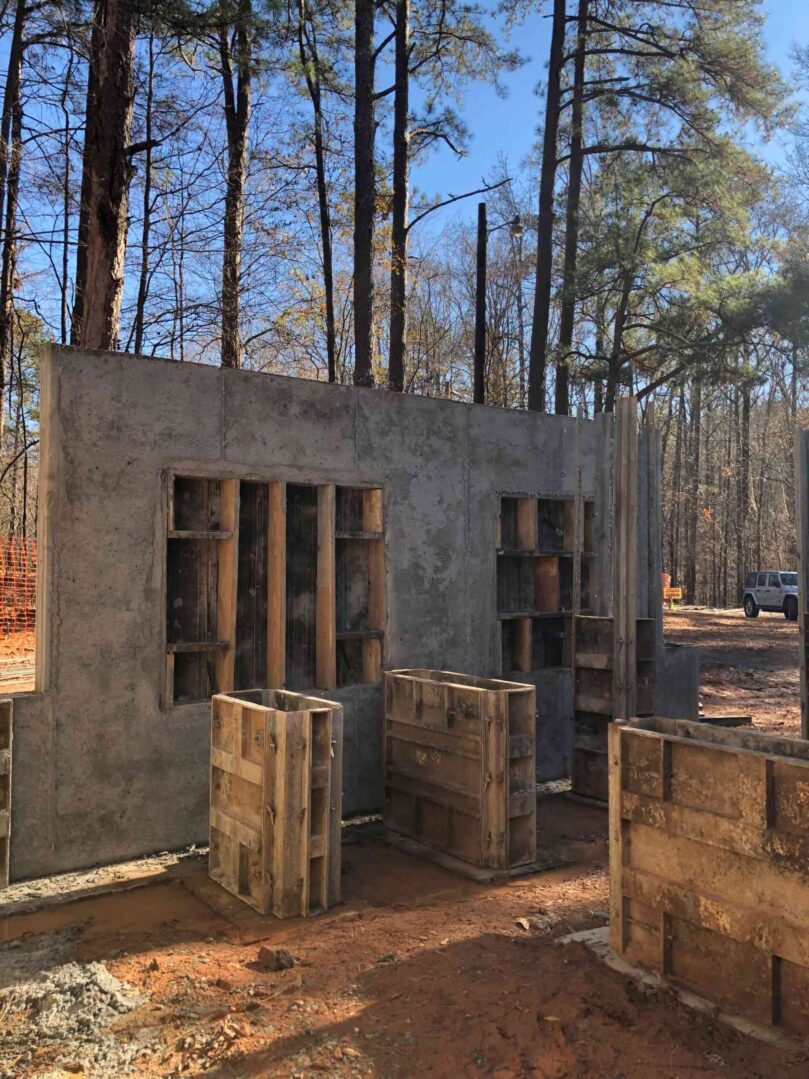 A building that is being built in the woods.