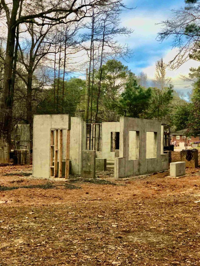 A building that is being built in the dirt.