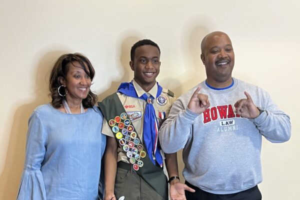 A man and two women standing next to each other.