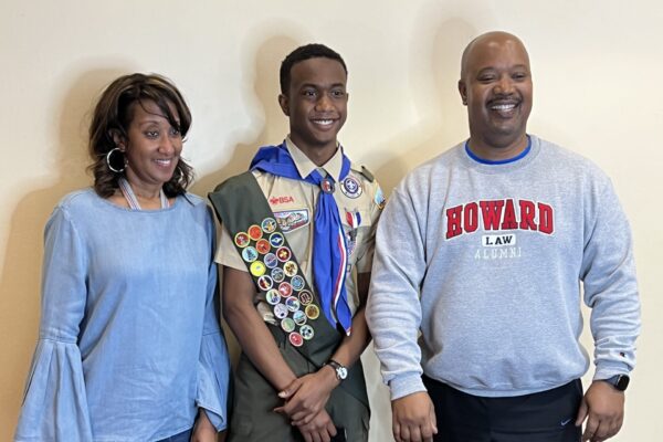 A man and two women standing next to him.