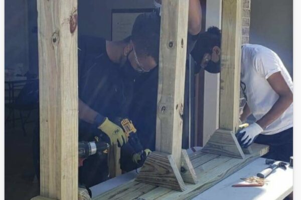 A group of people working on a window.