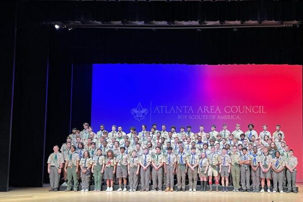 A group of people standing in front of a stage.