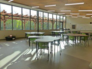 A room with many tables and chairs in it