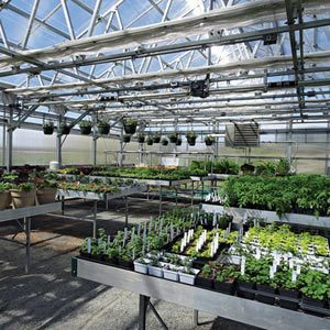 A greenhouse filled with lots of plants and pots.