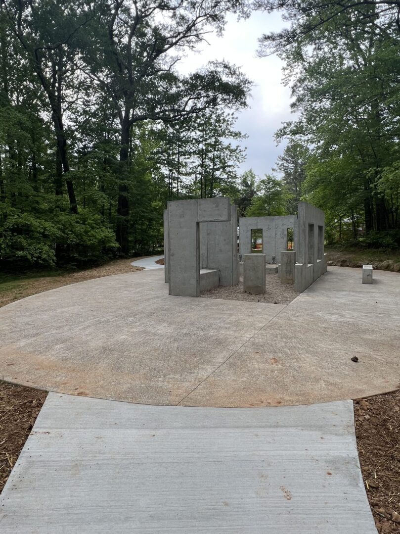 A concrete structure in the middle of a park.