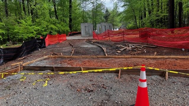 A road with trees and construction work on it.