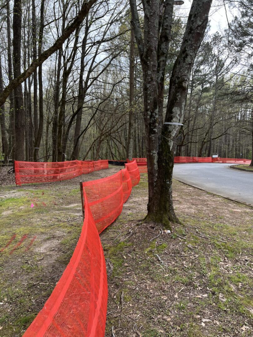 A red fence is blocking off the road.