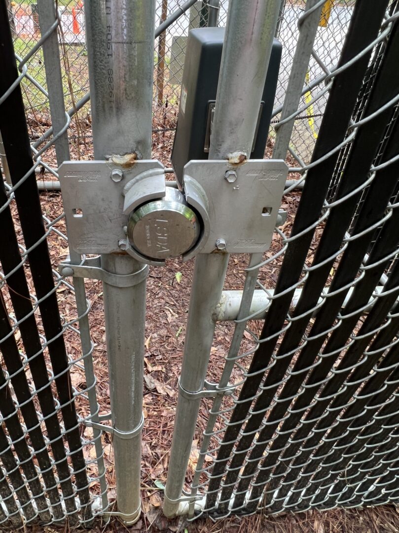 A metal gate with a lock on it.