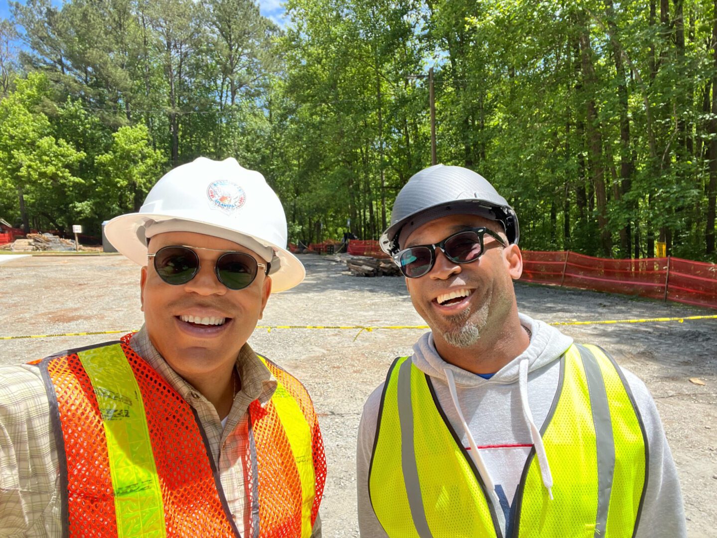 Two men in safety vests and hard hats.