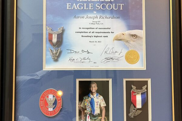 A framed eagle scout certificate and medal.