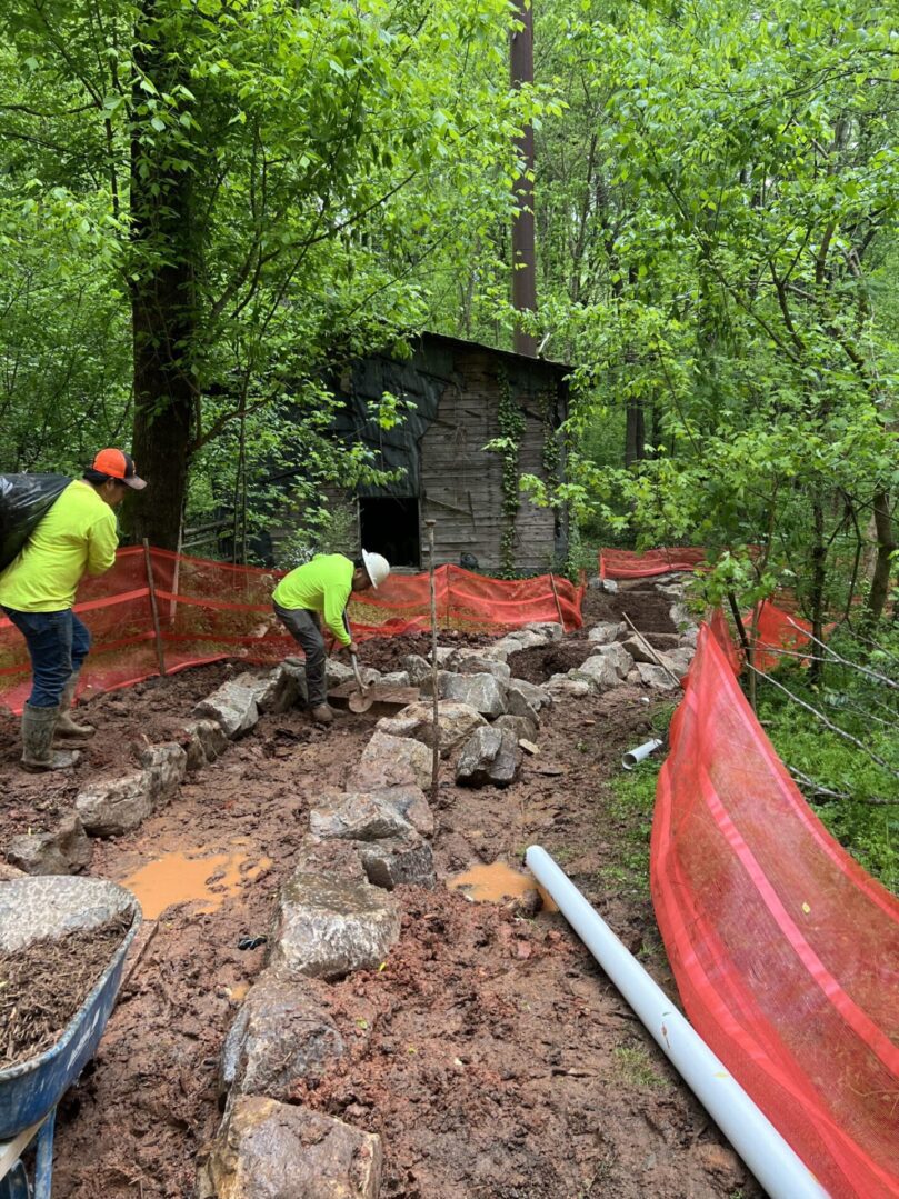 A group of people working on the side of a road.