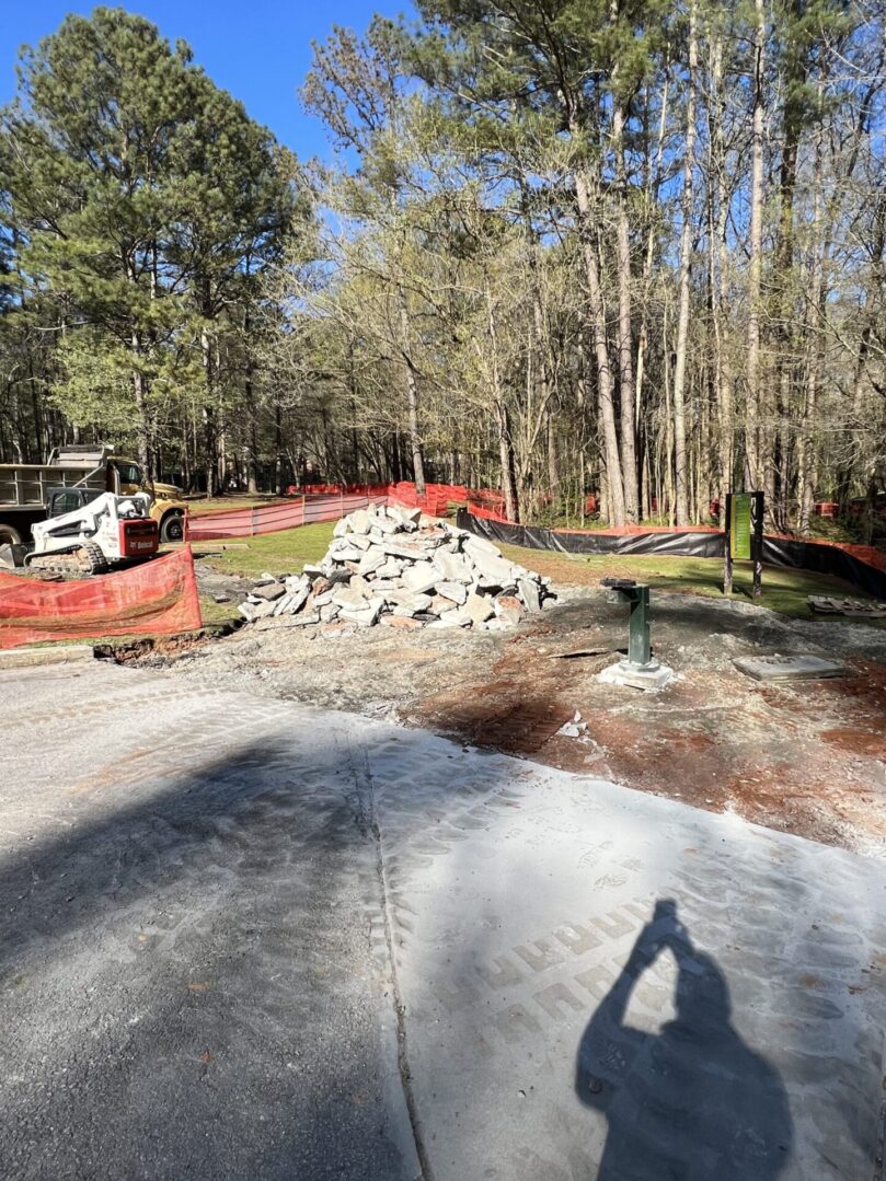 A view of a construction site with trees in the background.