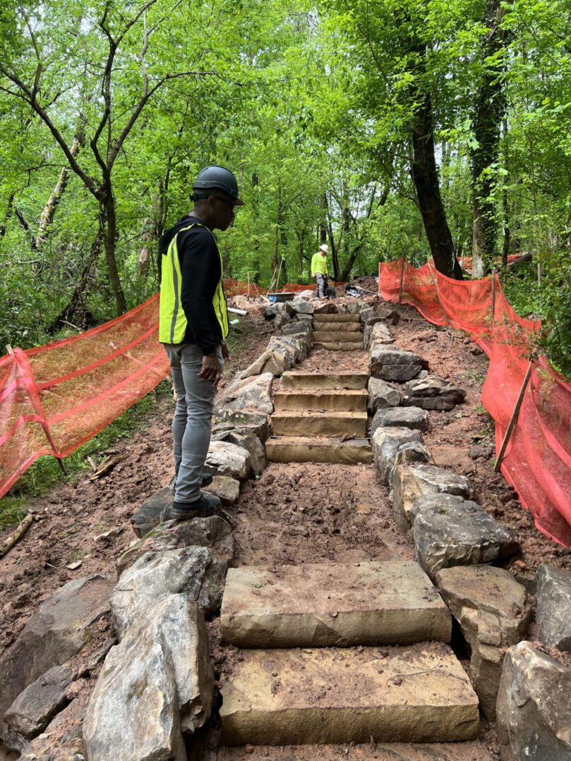 A man standing on some steps in the woods