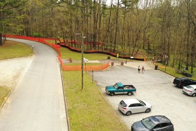 A couple of cars parked in the middle of a parking lot.