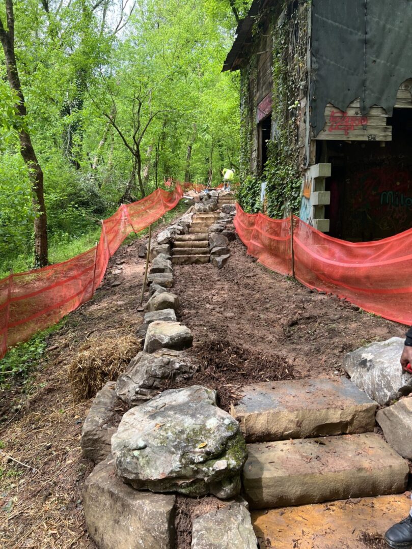 A path that is made of rocks and has red tape around it.