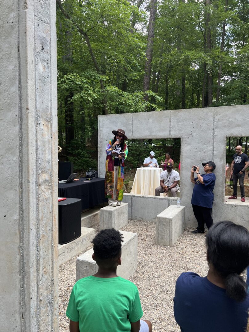 A group of people standing around in front of a stage.