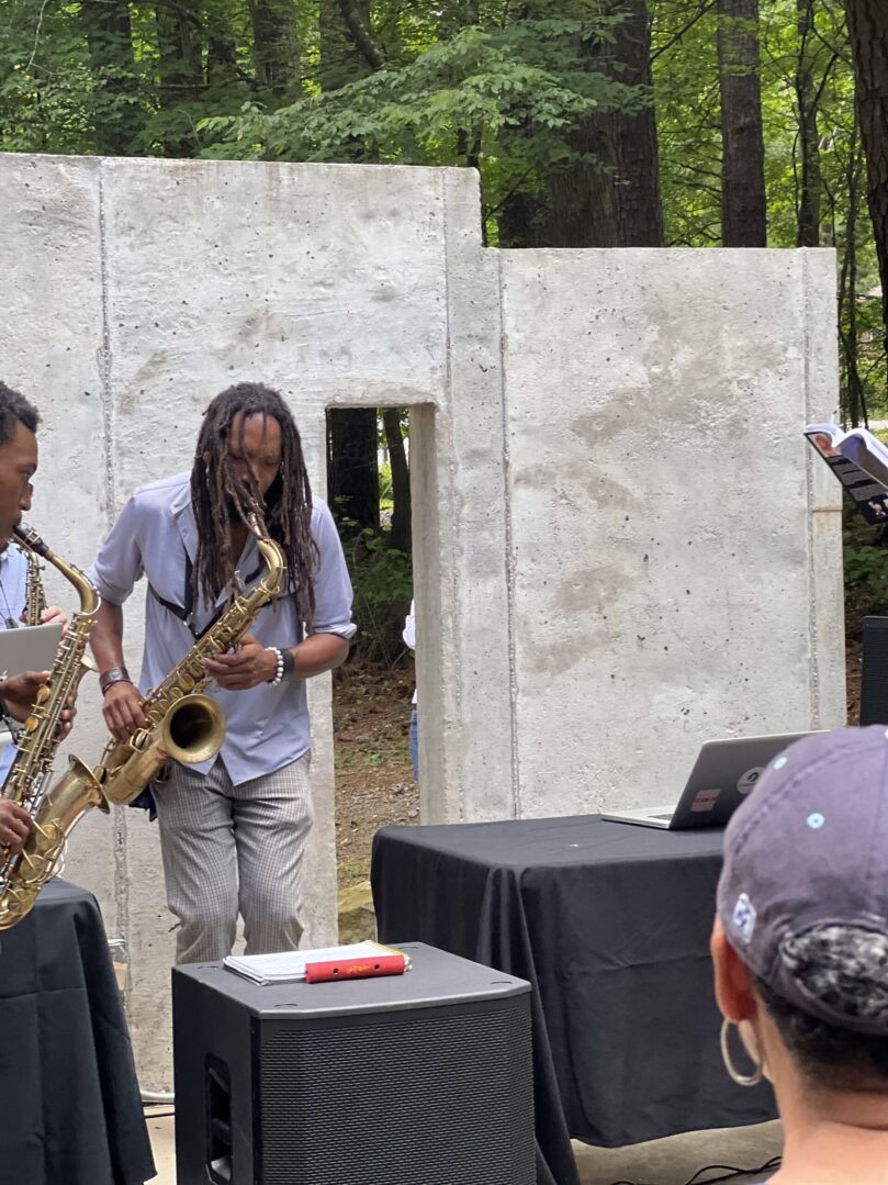 A group of people playing musical instruments in front of an audience.