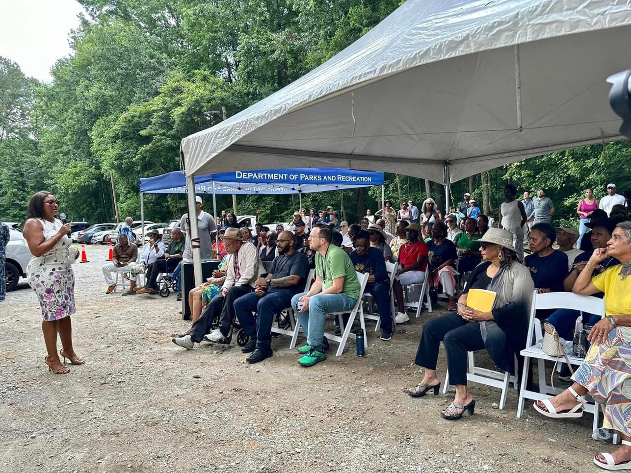 A group of people sitting under a tent.