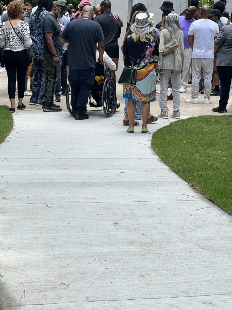 A group of people walking down the sidewalk.