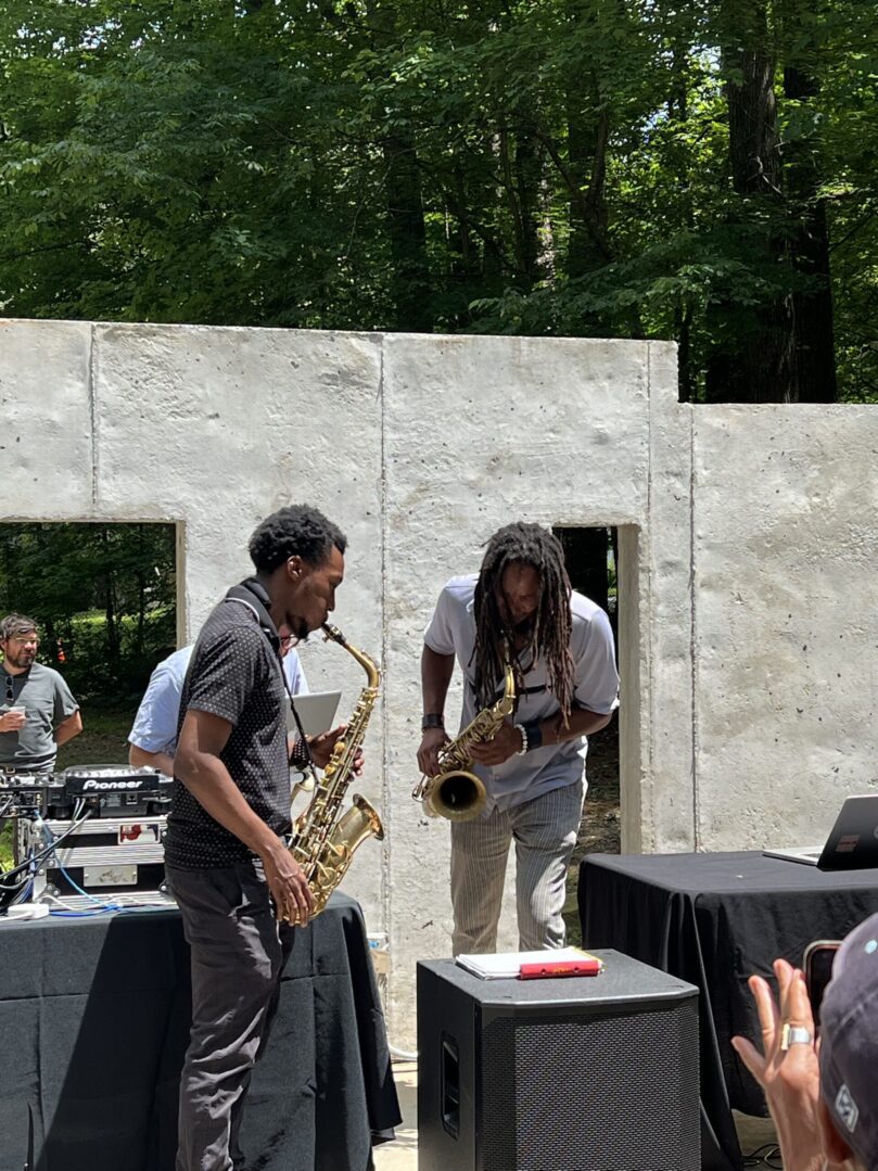 A group of people playing musical instruments in front of an audience.