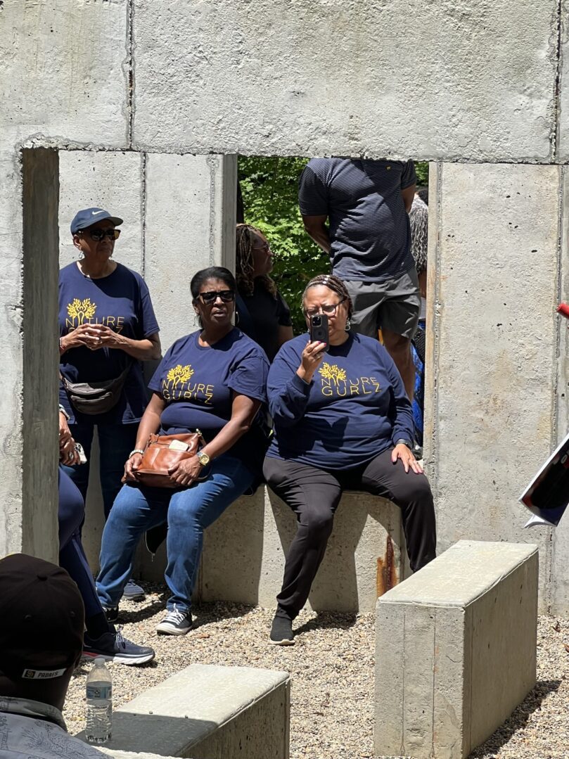 A group of people sitting on top of cement blocks.