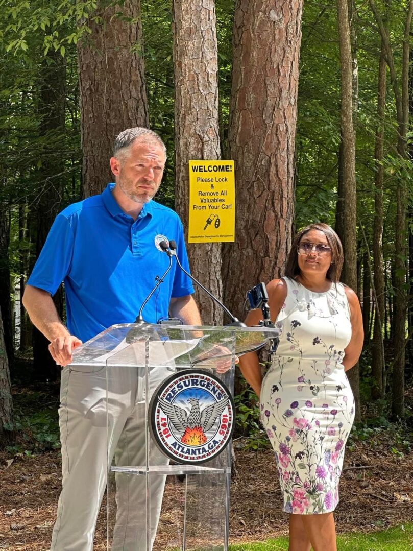 A man and woman standing in front of a podium.