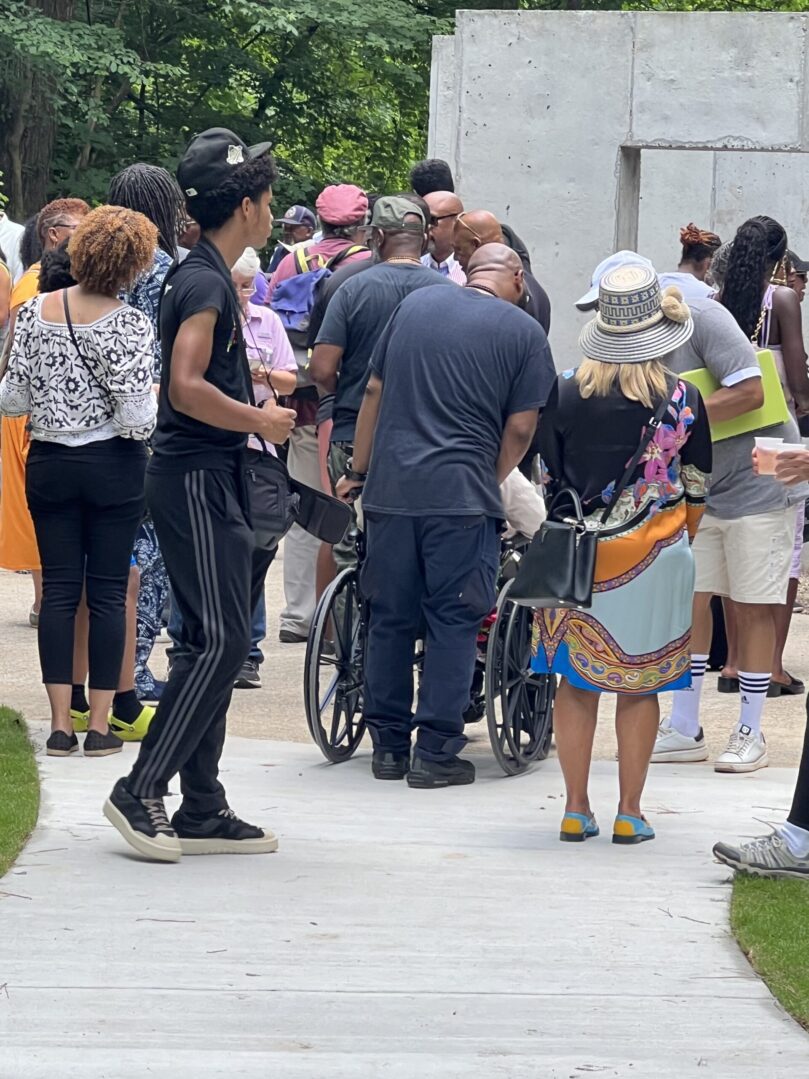 A group of people standing around each other.