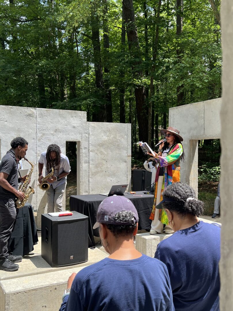 A group of people standing around in front of some walls.