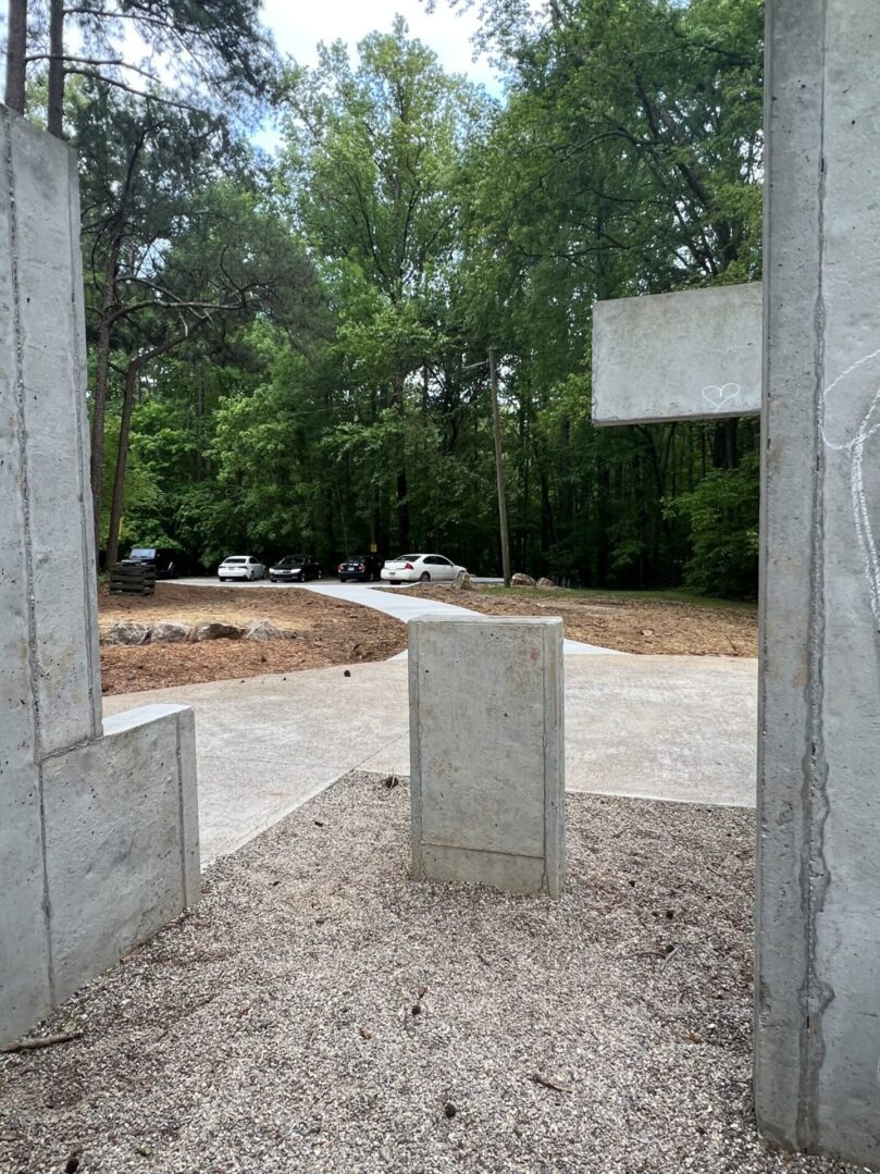 A concrete structure with trees in the background.