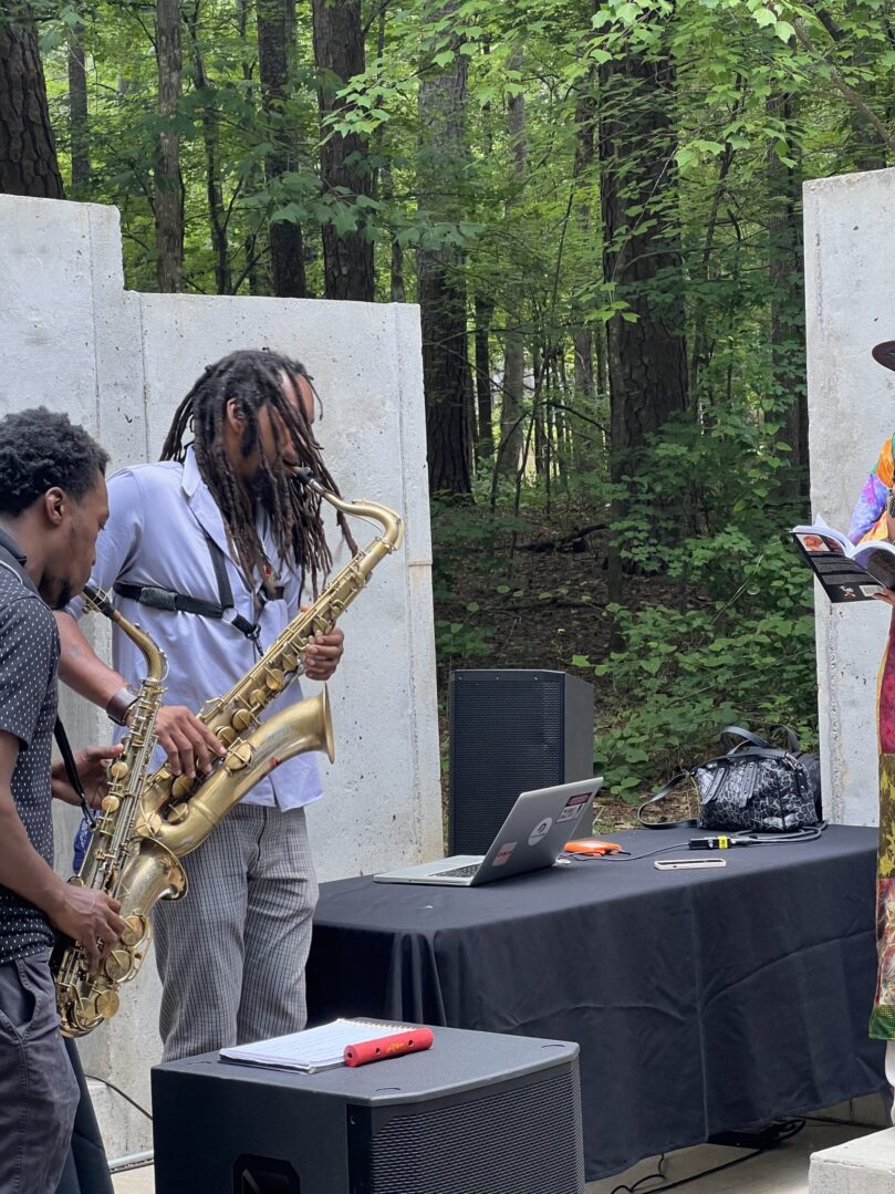 A group of people standing around with saxophones.