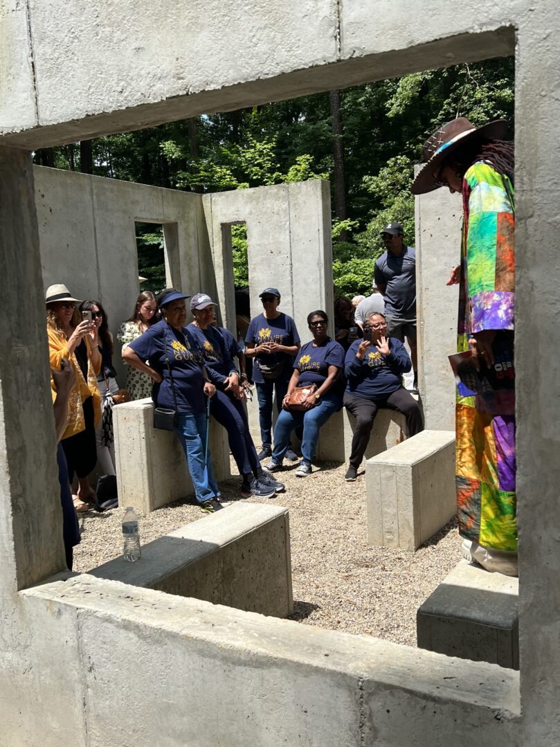 A group of people sitting in concrete blocks.