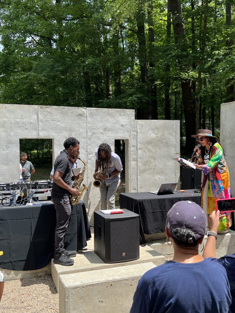 A group of people standing around in front of a stage.