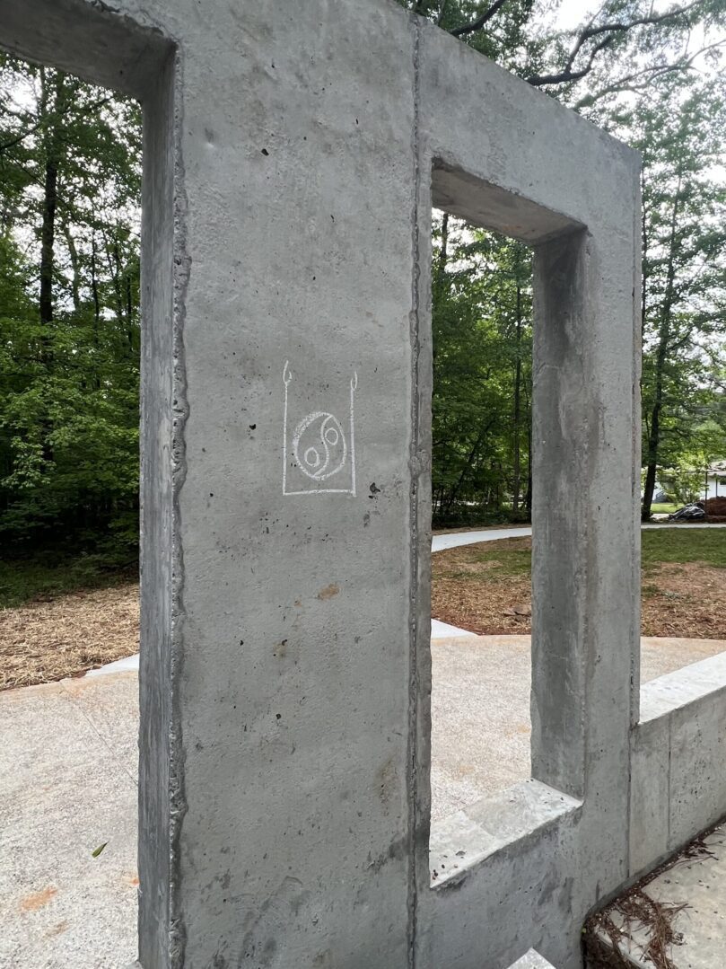 A concrete sculpture with a white circle on it.