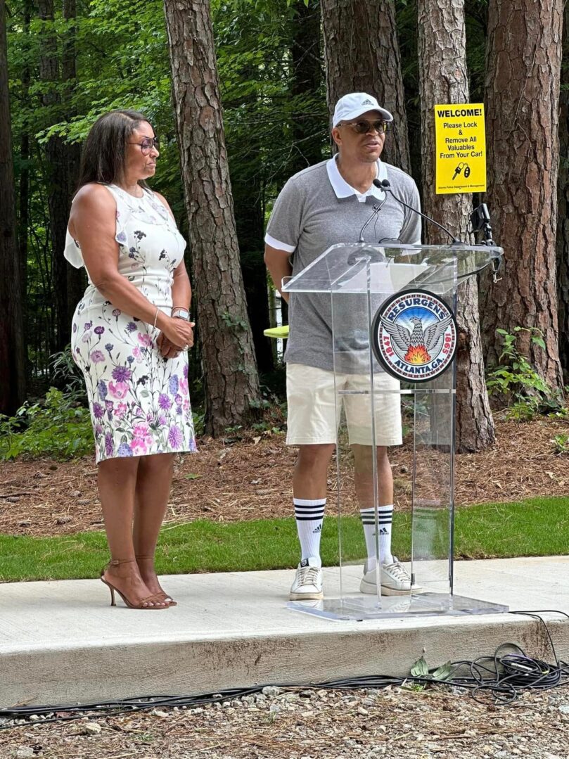 A man and woman standing at a podium.