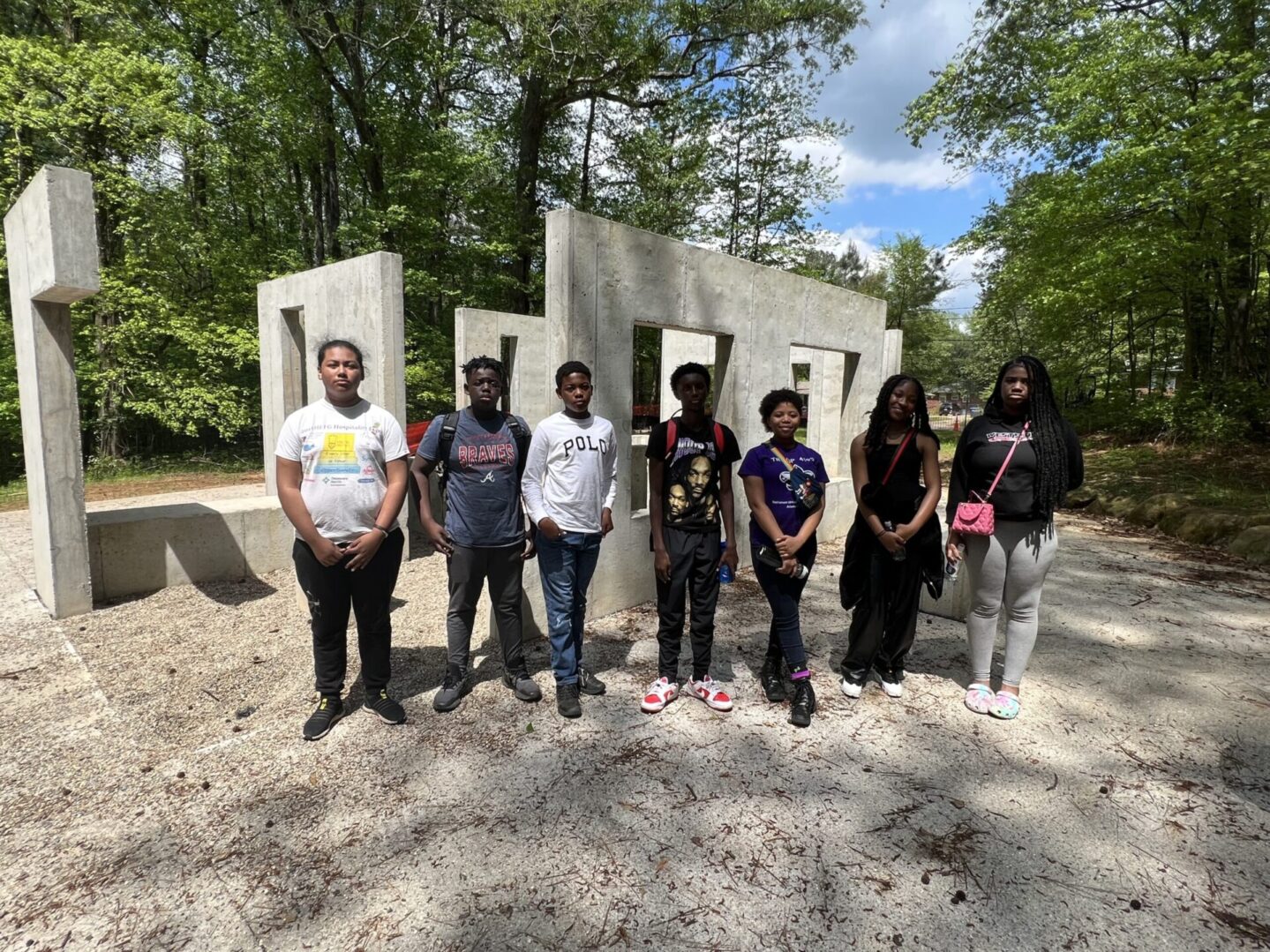 A group of people standing in front of concrete blocks.