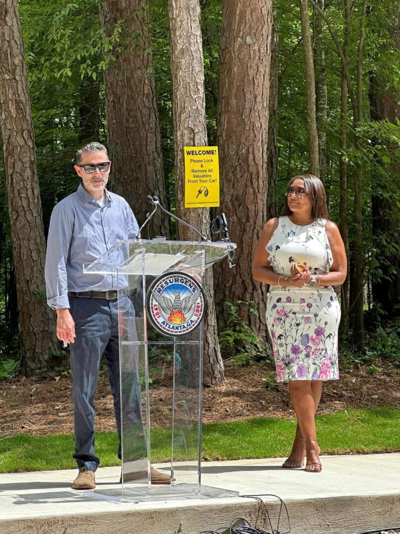 A man and woman standing next to a podium.